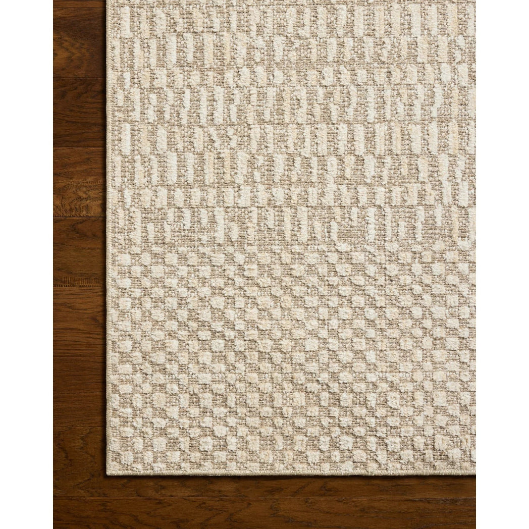 Textured beige rug on a wooden floor