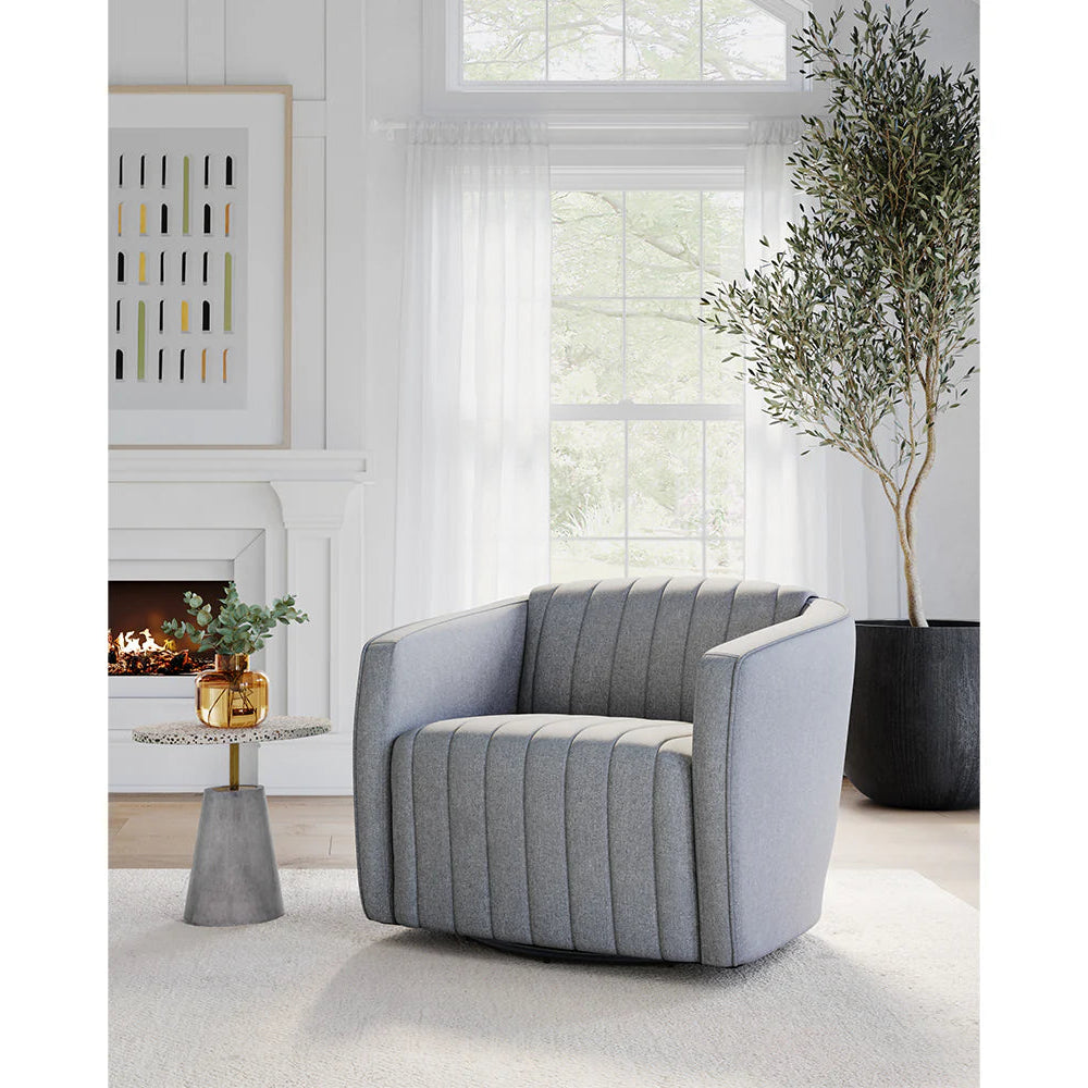Garrison Swivel Lounge Chair, Gray armchair in a modern living room with a fireplace and decorative elements.